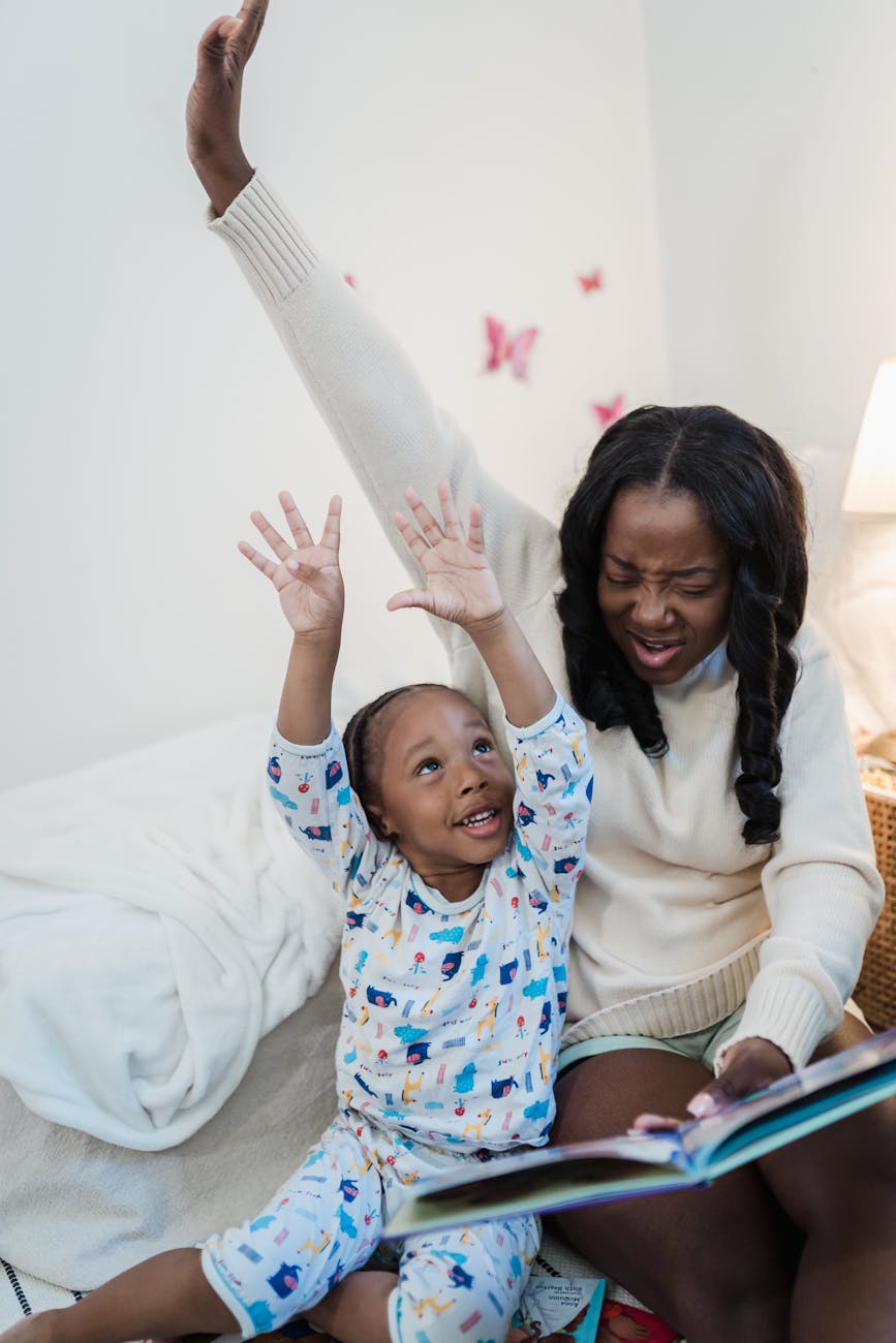 mother reading a book to her child in the bedroom