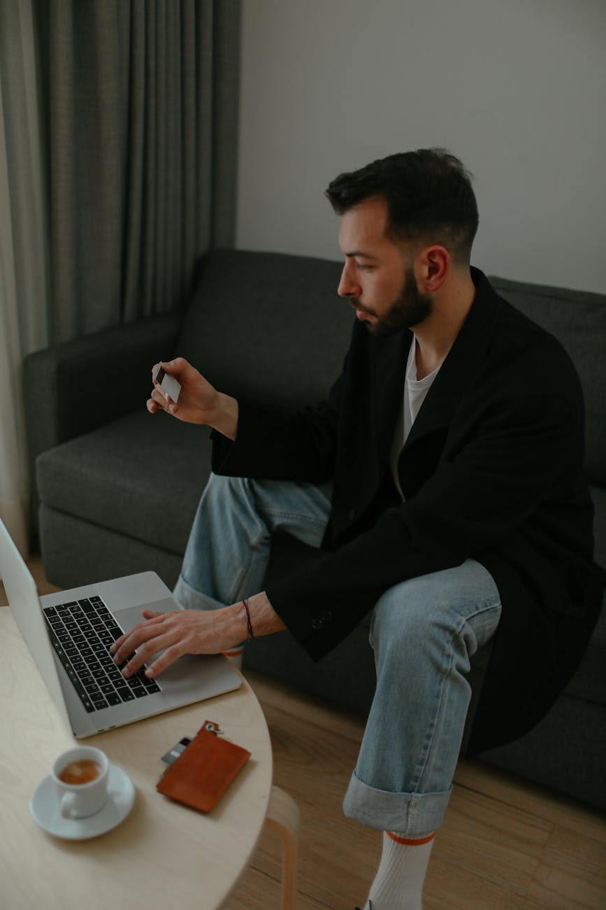 man using a credit card to pay online