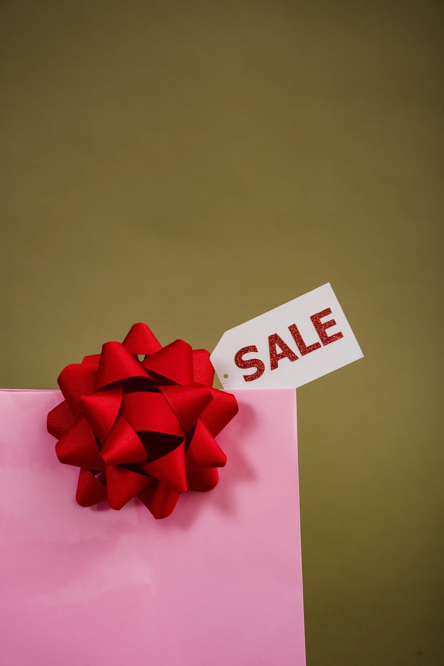 close up photo of pink paper bag with sale tag in it. georgefeola.io