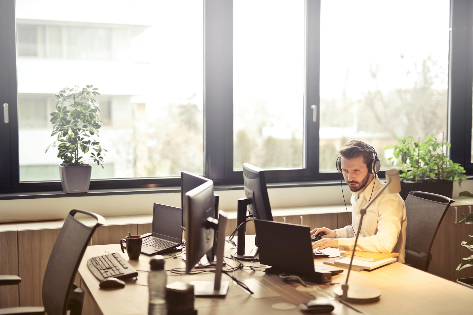 man with headphones facing computer monitor George Feola georgefeola.io