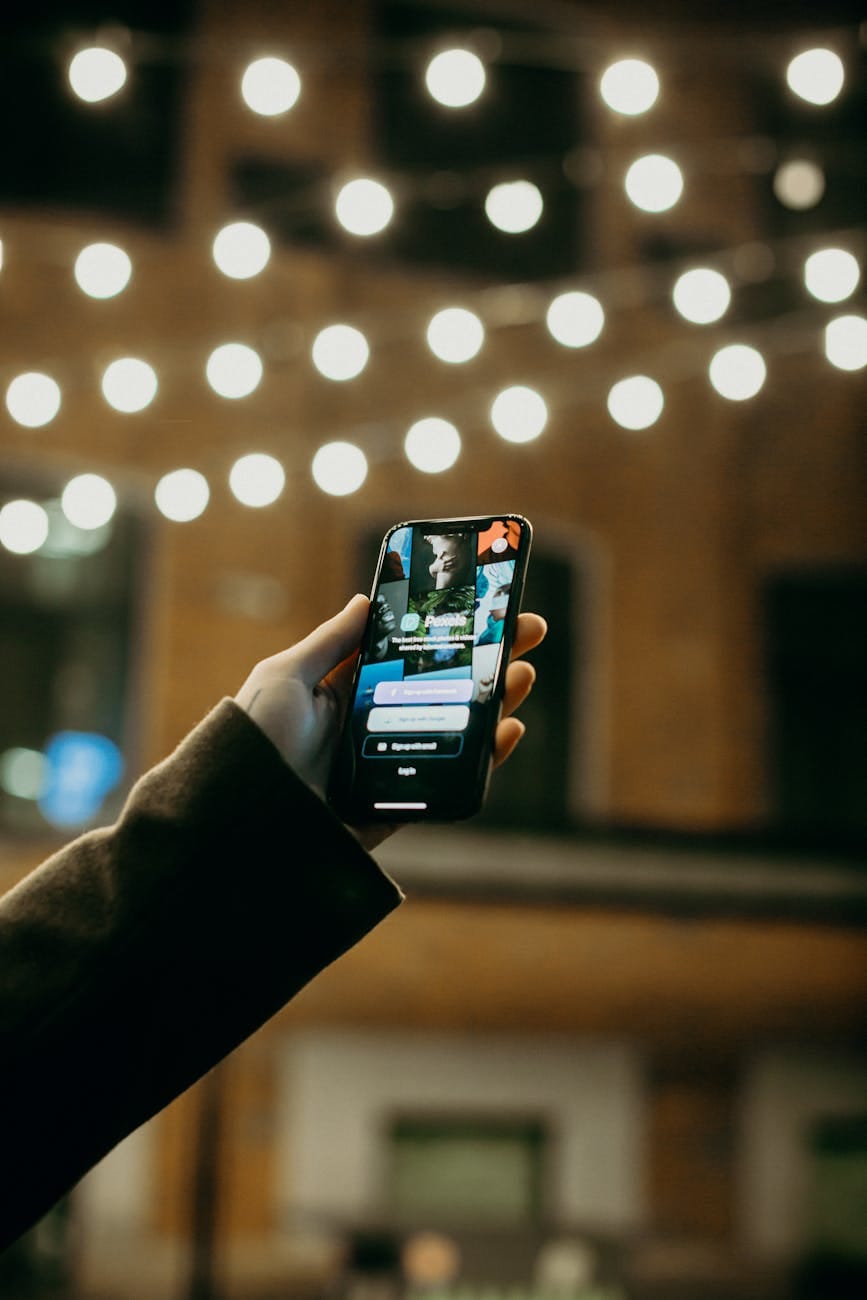 person holding smartphone george feola georgefeola.io