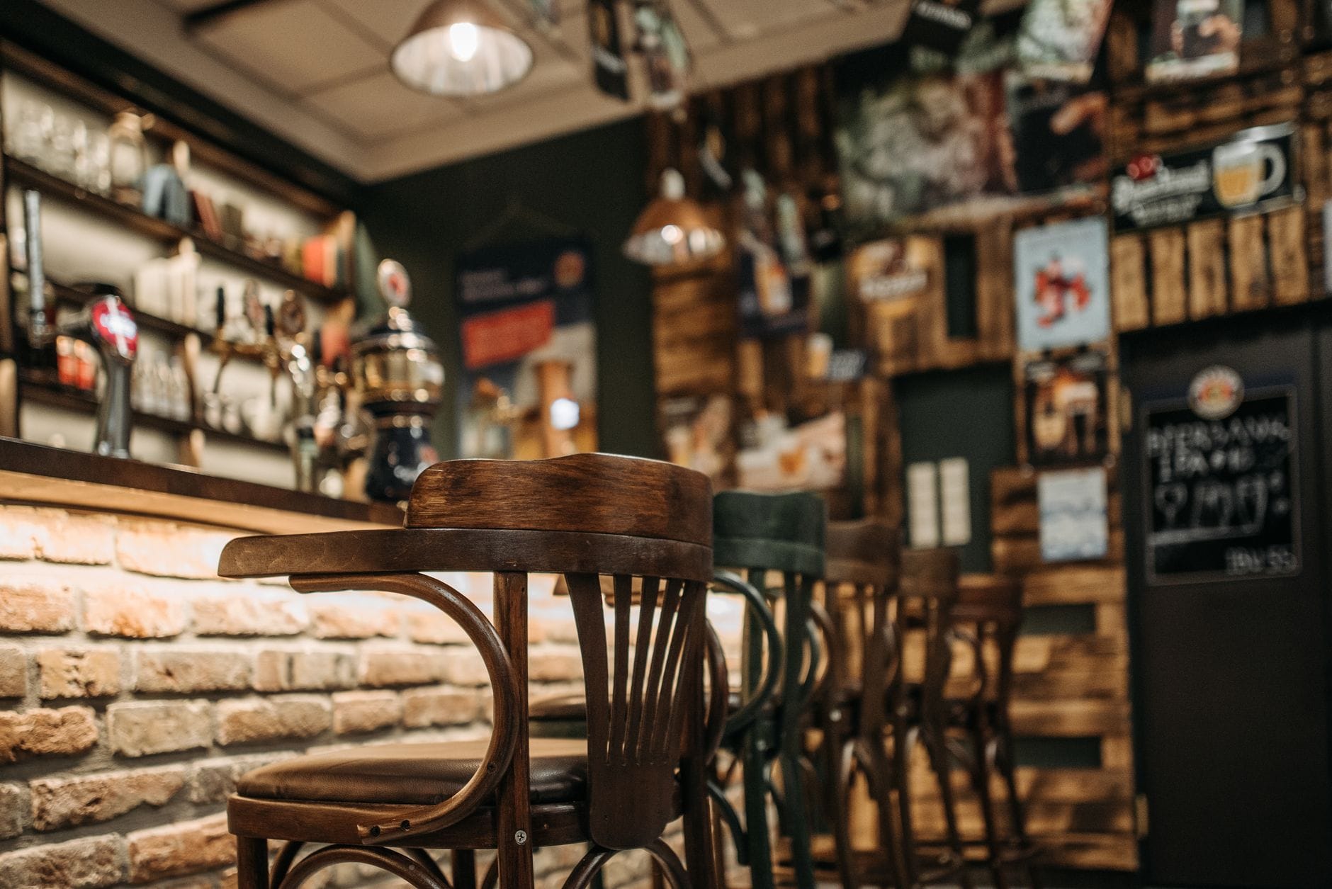 photo of wooden stools in a bar
