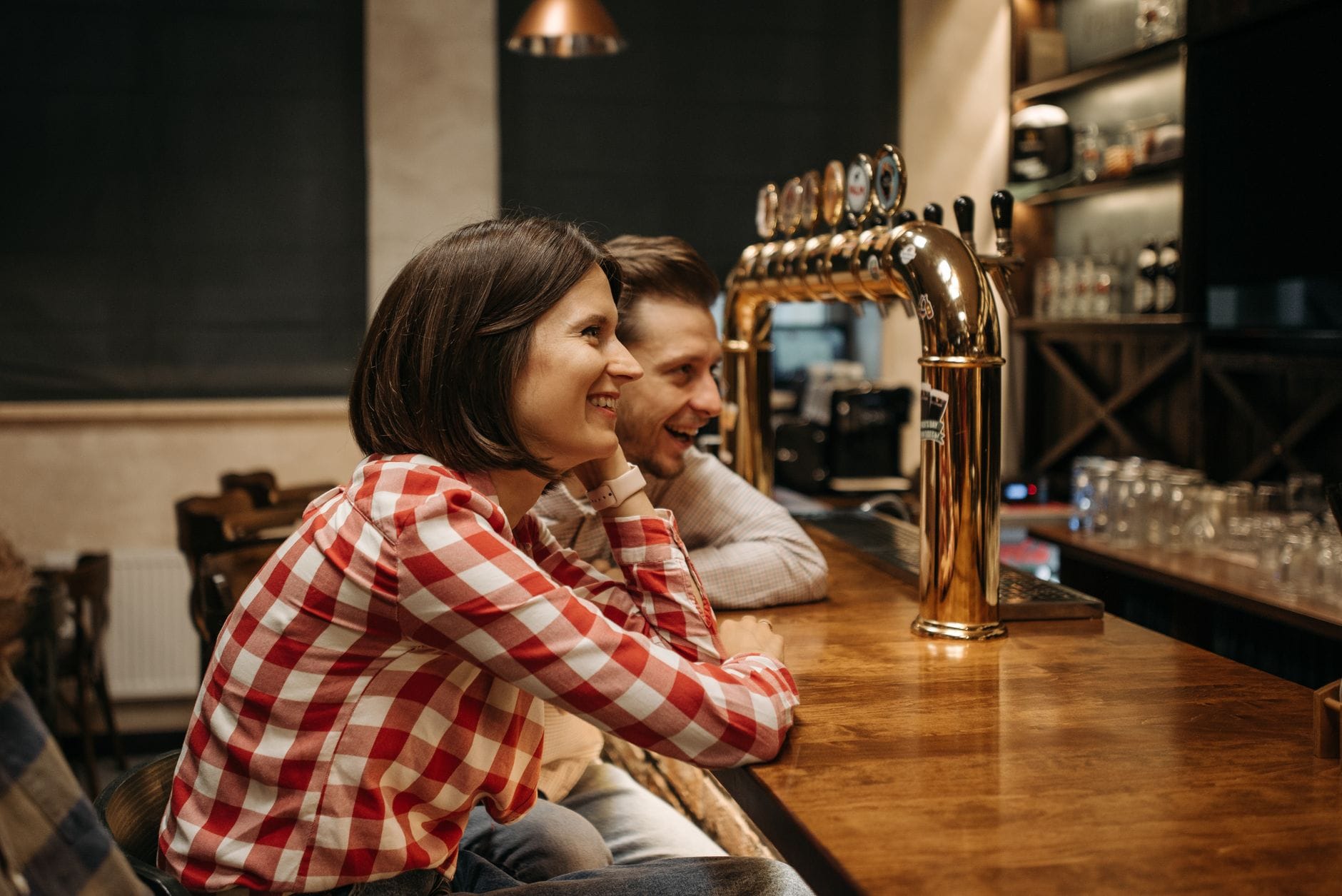 laughing couple sitting at bar counter